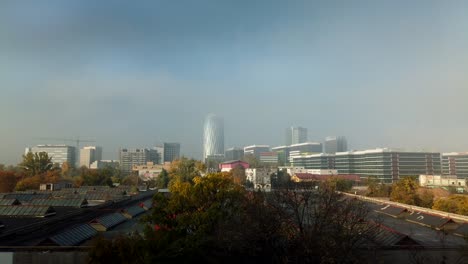 The-mist-and-the-clouds-revealing-the-trees-and-buildings,-under-a-blue-sky-and-time-lapse-record