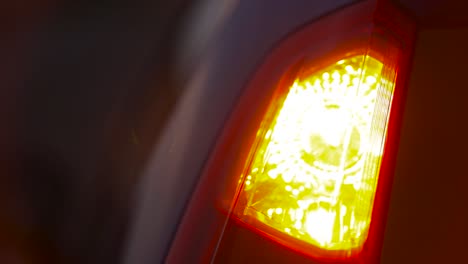 Rear-car-hazard-light-at-night---accident-at-bad-conditions