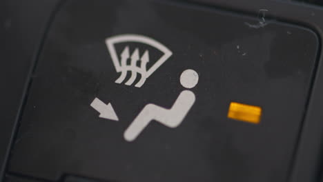 Close-up-of-a-finger-turning-on-the-defog-heater-button-in-a-car