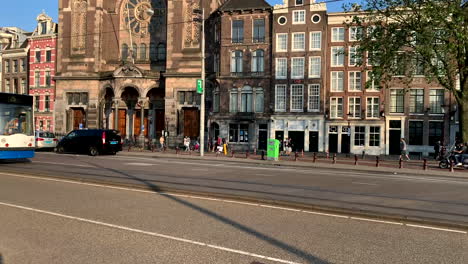 Tram-drives-through-the-city-center-of-Amsterdam-Netherlands-in-good-weather