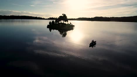 Beautiful-Colorado-sunrise-on-a-lake-with-a-silhouette-of-a-canoe-against-the-rising-sun