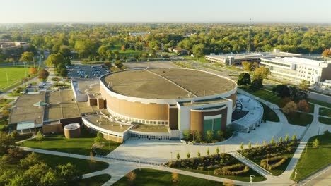 Aerial,-all-weather-indoor-stadium-at-Michigan-State-University-campus,-wide-shot