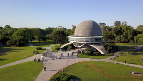 Aerial-of-people-wandering-near-Galileo-Galilei-Planetarium,-Buenos-Aires