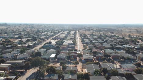 A-Pan-Left-Drone-Shot-of-Township-Housing-Complex-Under-Sunny-Conditions