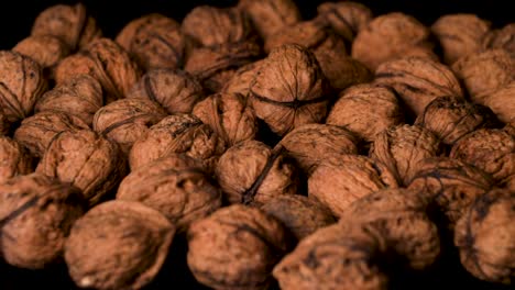 Organic,-Vegan-Approved-Walnuts-Falling-into-Pile,-Close-Up,-Slow-Motion