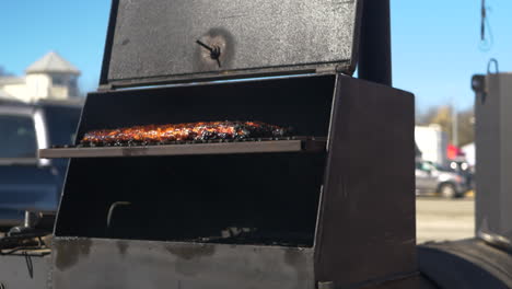 BBQ-Rack-of-Ribs-in-a-smoker-sizzling