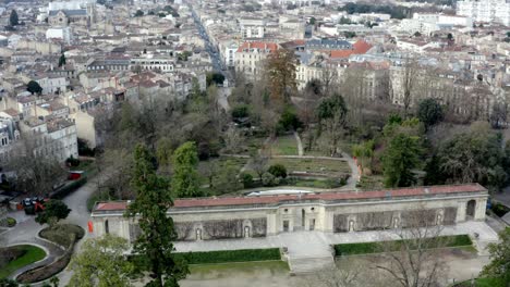 Botanical-garden-of-Bordeaux,-France-with-central-long-gate-building,-Aerial-right-pan-reveal