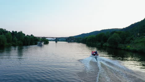 Evening-drone-footage-following-a-fast-boat-on-Vltava-river