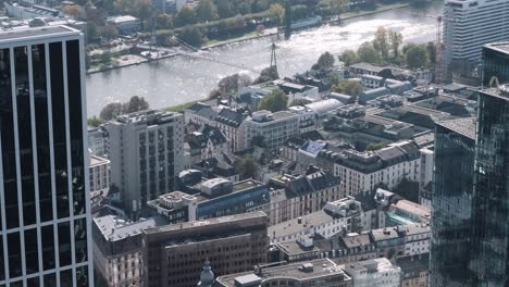 Static-shot-aerial-view-from-main-tower-towards-main-river-with-a-lot-of-roofs-and-buildings,-Frankfurt,-Hessen,-Germany