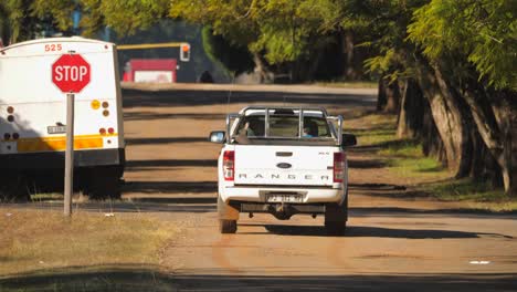 Bakkie-or-pickup-truck-drives-through-a-stop-sign-without-stopping-correctly,-breaking-road-rules,-South-Africa