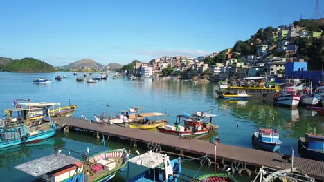Drone-crossing-a-pier-full-of-boats-in-a-beautiful-sunny-day---Vitória,-Espírito-Santo-Brazil