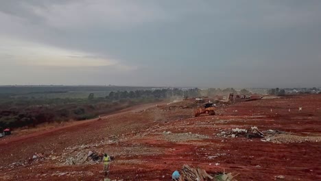 bulldozers-move-piles-of-garbage-during-waste-compaction-process-at-the-municipal-landfill