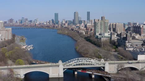Aerial-Drone-View-Of-Boston-University-Bridge,-Tilting-Up-Shot-Revealing-Boston-Skyline-And-Charles-River