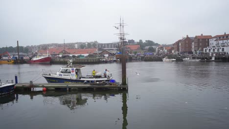 Fishermen-washing-off-equipment-in-the-harbour-at-Whitby-after-unloading-the-catch