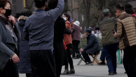 Happy-active-group-of-Chinese-seniors-gathered-dancing-in-public-park-together