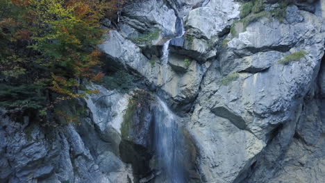 Drohne-Fliegt-Rückwärts-Und-Blickt-Auf-Einen-Wasserfall-In-Den-österreichischen-Alpen