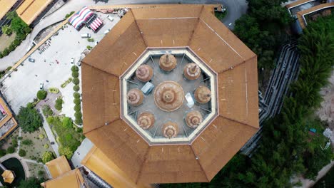 Kuan-Yin-Goddess-of-Mercy-building-top-view-in-Kek-Lok-Si-Buddhist-temple,-Aerial-drone-lowering-close-up-shot