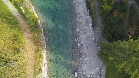 drone-ascending-fast-above-a-colourful-mountainstream