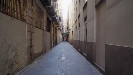Steady-forward-pov-of-narrow-street-and-poor-homeless-man-approaching