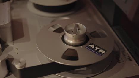 An-ATR-Master-Tape-Spinning-On-The-Reel-In-The-Studio---closeup-shot