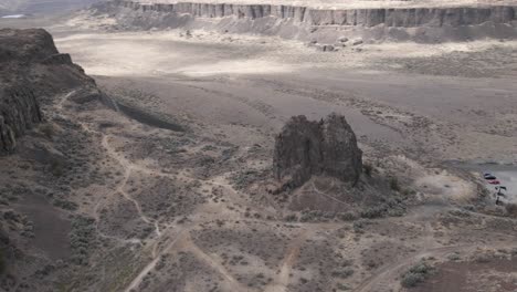 Slow-aerial-orbit-of-a-large-rock-formation-revealing-Frenchman's-Coulee-State-Park,-WA