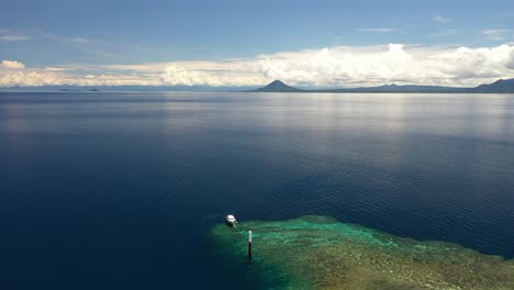 Drone-shot-of-a-small-island-in-the-middle-of-the-ocean