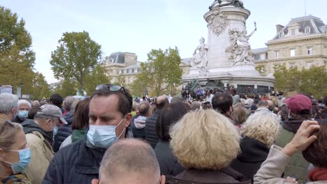 Shot-of-People-Gathering-On-Place-De-La-Republique-in-Honor-of-Samuel-Paty,-The-Teacher-killed-by-a-Terrorist-in-Conflans,-Paris-France