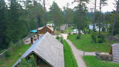 Outdoor-summer-cabins-in-the-woods-and-lake-above-view-a-quiet-place-in-Slovenia