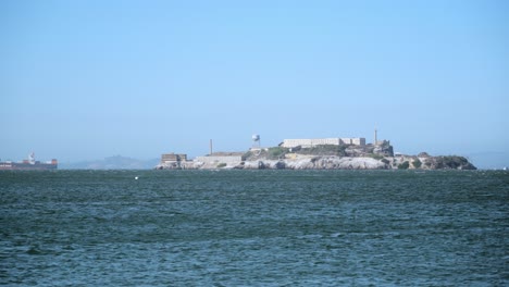 San-Francisco-Bay-Area,-Alcatraz-Island-and-Cargo-Ship-Passing-by