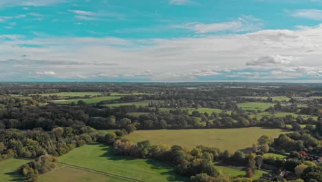 Pan-around-drone-shot-over-the-green-English-countryside-fields