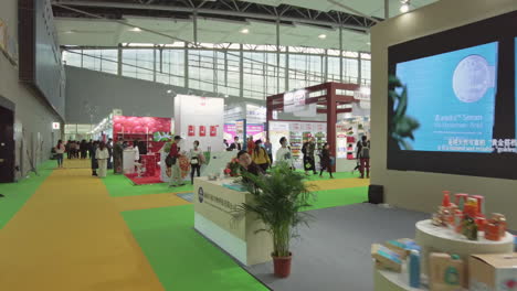 View-of-exhibition-visitors-walking-in-expo-hall-between-the-booths-at-Health-products-exhibition-in-Guangzhou,-China-during-COVID-19-Pandemic