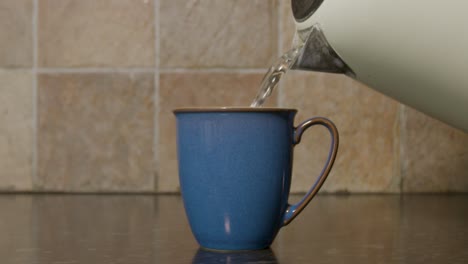 Pouring-hot-water-into-a-mug-in-slow-motion