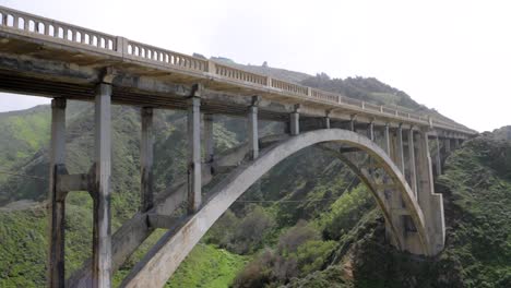 Ultra-slow-motion-shot-of-Bixby-Creek-Bridge-camera-tilting-up---California,-USA