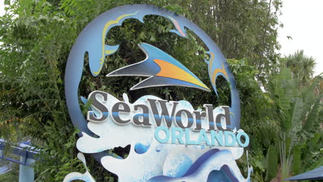 Main-Enterance-Sign-at-SeaWorld-Orlando,-Static-View-with-Green-Vegetation-in-the-Background,-No-People