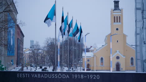 Six-Estonian-flags-flying-near-War-of-Independence-Victory-Column-near-Freedom-Square,-Tallinn-with-St