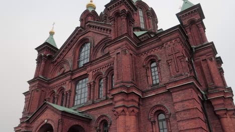 Uspenski-orthodox-cathedral-in-Helsinki,-dolly-out,-shot-from-the-ground-looking-up-during-an-overcast-day
