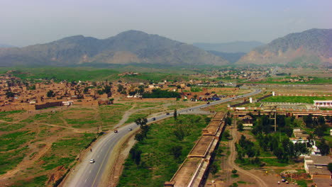 Peshawar,-Pakistan,-Aerial-view-of-busy-mountain-pass-connecting-the-Pak-Afghan-border-through-white-range-with-valley-of-Peshawar