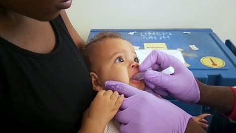 A-baby-is-vaccinated-with-liquid-drops-at-a-medical-clinic-in-Africa