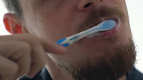 Close-up-tight-shot-of-a-man-brushing-teeth,-detail
