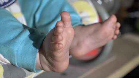 Feet-of-newborn-baby-closeup-outdoors