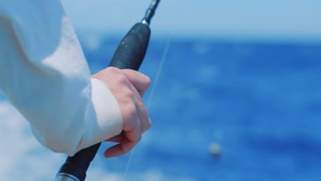 Closeup On Man Resting Hand On Trolling Fishing Rod, Rack Focus To  Caribbean Sea Free Stock Video Footage Download Clips