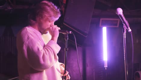 Atlanta,-GA---December-15,-2018:-A-male-R-B-singer-with-long-blond-hair,-Wiley-from-ATL,-sings-passionately-during-a-lively-concert-in-an-underground-urban-nightclub-popular-with-millennials