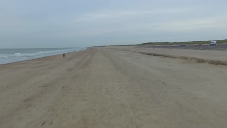 Aerial:-An-overcast-day-at-the-sand-beach-between-Domburg-and-Westkapelle,-the-Netherlands