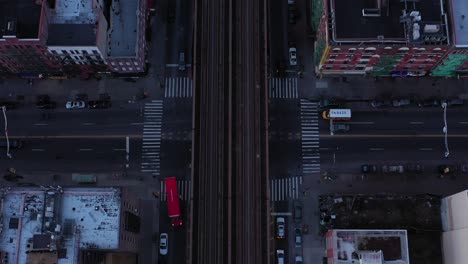 Epic-drone-pan-up-perpendicular-along-train-tracks-in-Harlem-just-after-sunrise,-great-reveal-of-midtown-Manhattan,-NYC