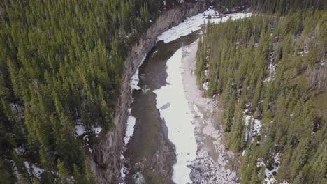 Aerial-view-of-a-boreal-river-canyon-wall-in-spring