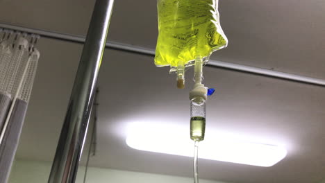 Yellow-bag-of-intravenous-chelation-therapy-dripping-slowly-in-a-hospital-room