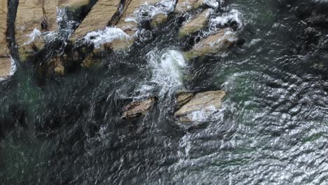 Bird's-eye-drone-footage-of-waves-crashing-on-the-rocks