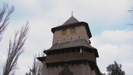Traditional-romanian-church-from-Galati-city-surrounded-by-trees,-tilt-up-video