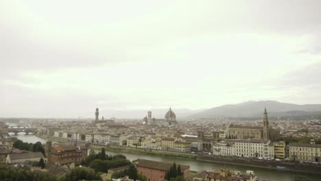 Slow-motion-pan-above-the-ancient-rooftops-of-rainy-Florence,-Italy