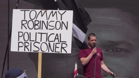 A-Tommy-Robinson-supporter-addresses-a-crowd-outside-the-BBC-studio-in-London